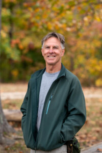 Glen smiling in front of autumn colors